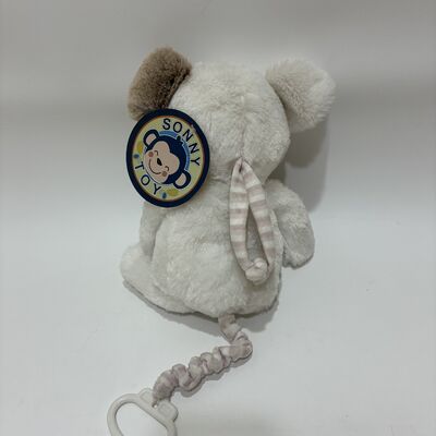 Un chien en peluche doux, une boîte à musique pour bébés, un bébé endormi, un jouet en peluche.