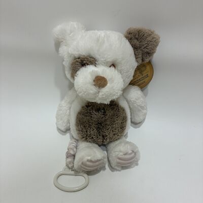 Un chien en peluche doux, une boîte à musique pour bébés, un bébé endormi, un jouet en peluche.
